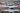 Several American Airlines planes on the runway waiting for takeoff clearance