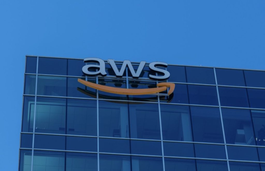 A large glass building with the letters “AWS” displayed prominently at the top