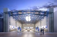 A stunning Apple store with the iconic apple logo displayed above it