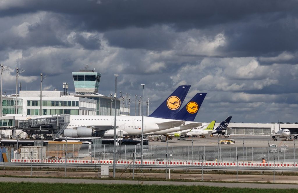 Munich airport with several planes parked, waiting for clearer skies