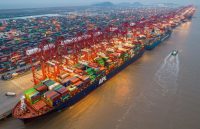 China’s largest port, with hundreds of shipping containers and several cargo ships being loaded by massive cranes