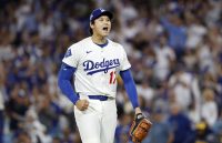 Dodgers sweep the Brewers and advance to the World Series thanks to Shohei Ohtani’s magic The Japanese baseball player standing on the mound, holding his glove and the ball right before making the pitch