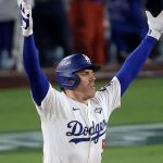The Canadian player raising his hands after hitting a home run to win the game for his team