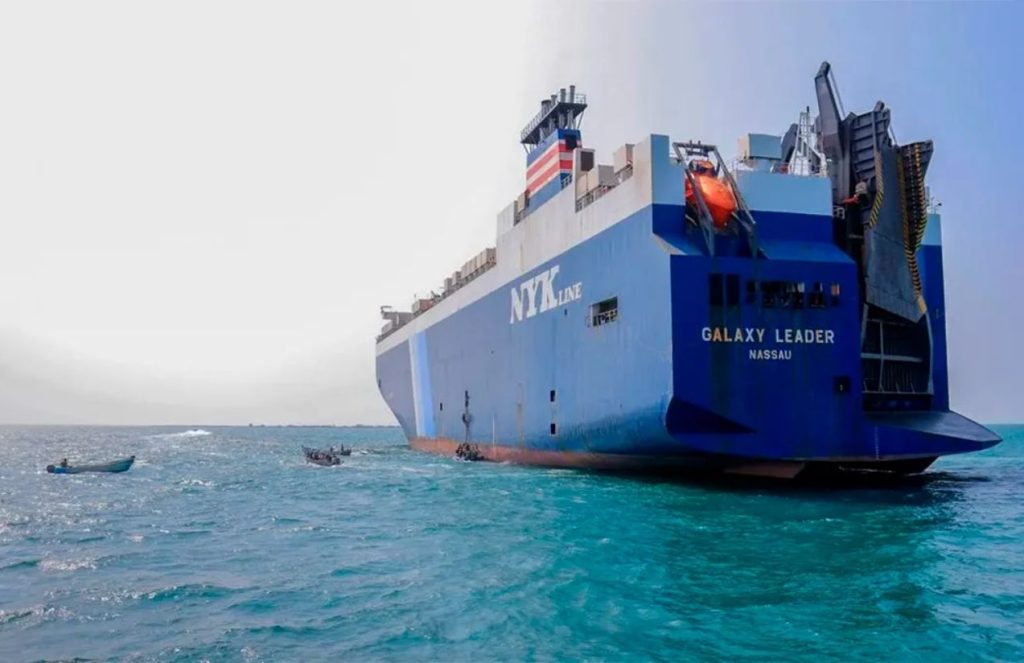 A ship being assisted by smaller vessels in the middle of an attack