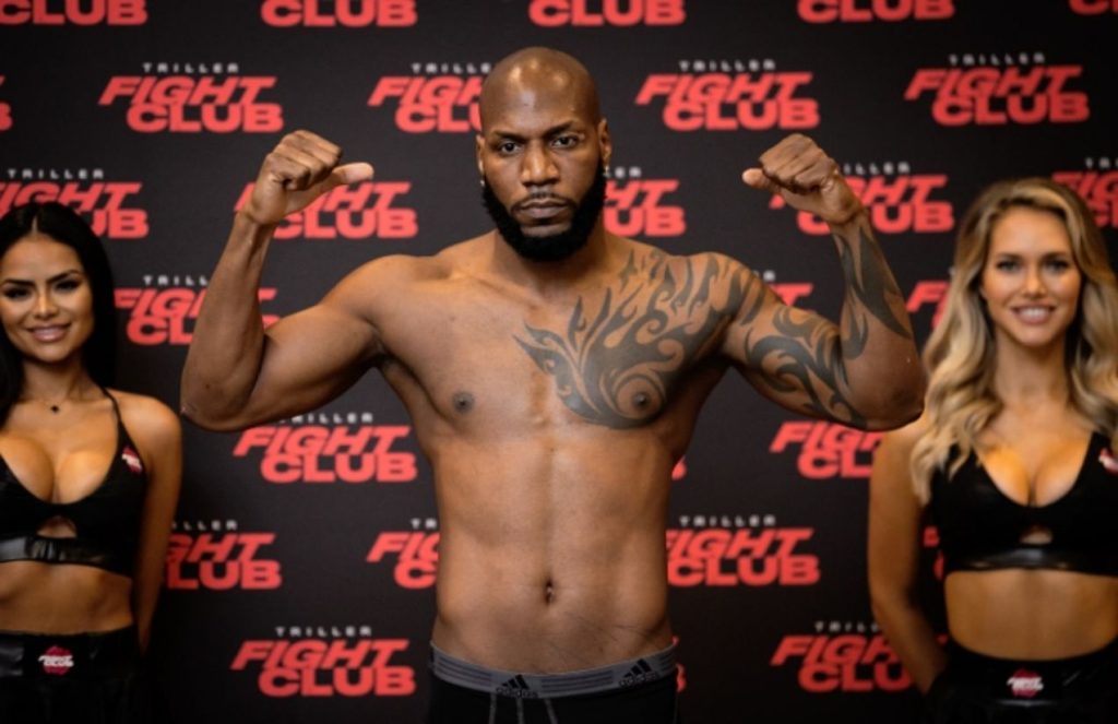 The famous boxer posing and flexing his muscles toward the camera