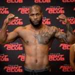 The famous boxer posing and flexing his muscles toward the camera