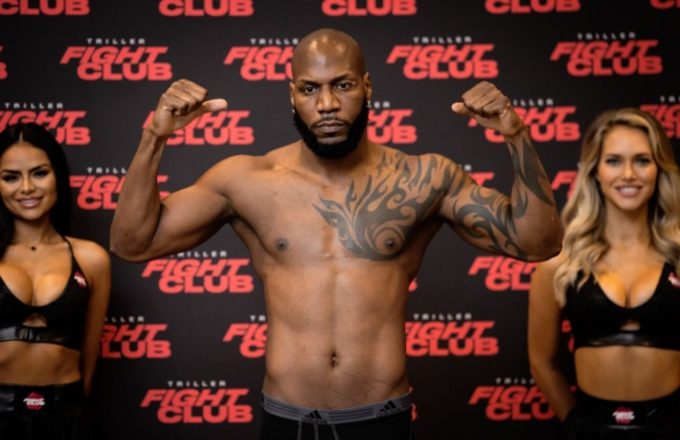 The famous boxer posing and flexing his muscles toward the camera