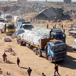 Several trucks loaded with food, medicine, and other essential supplies move through Israel’s trenches on their way to Gaza
