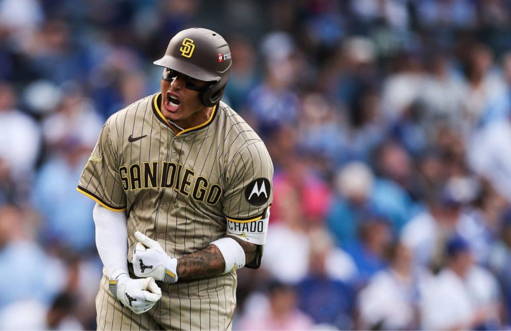 Machado celebrating his three-run homer with great euphoria