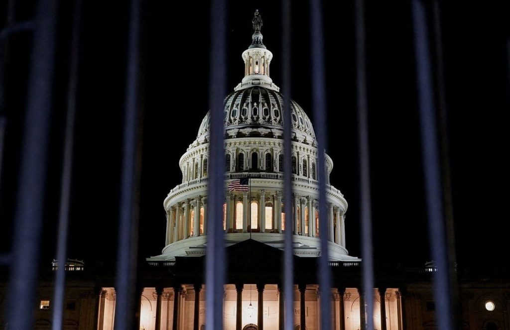 The majestic White House seen at night, illuminated by lights that make it shine and look like a wonder of the world