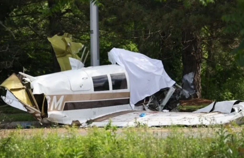 a white plane crashed in the middle of the highway