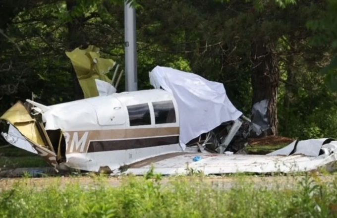 a white plane crashed in the middle of the highway