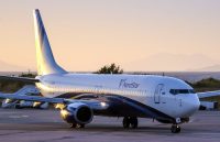A large airplane parked on a runway after an emergency landing at an airport