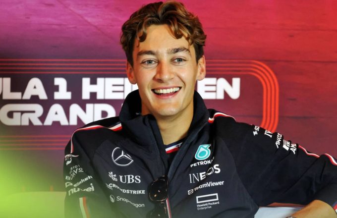 The famous driver wearing his black racing suit during a press conference after finishing in first place