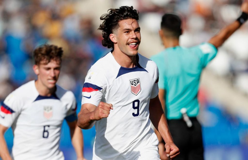 The number 9 of the U.S. U-20 national team celebrating his goal with the crowd