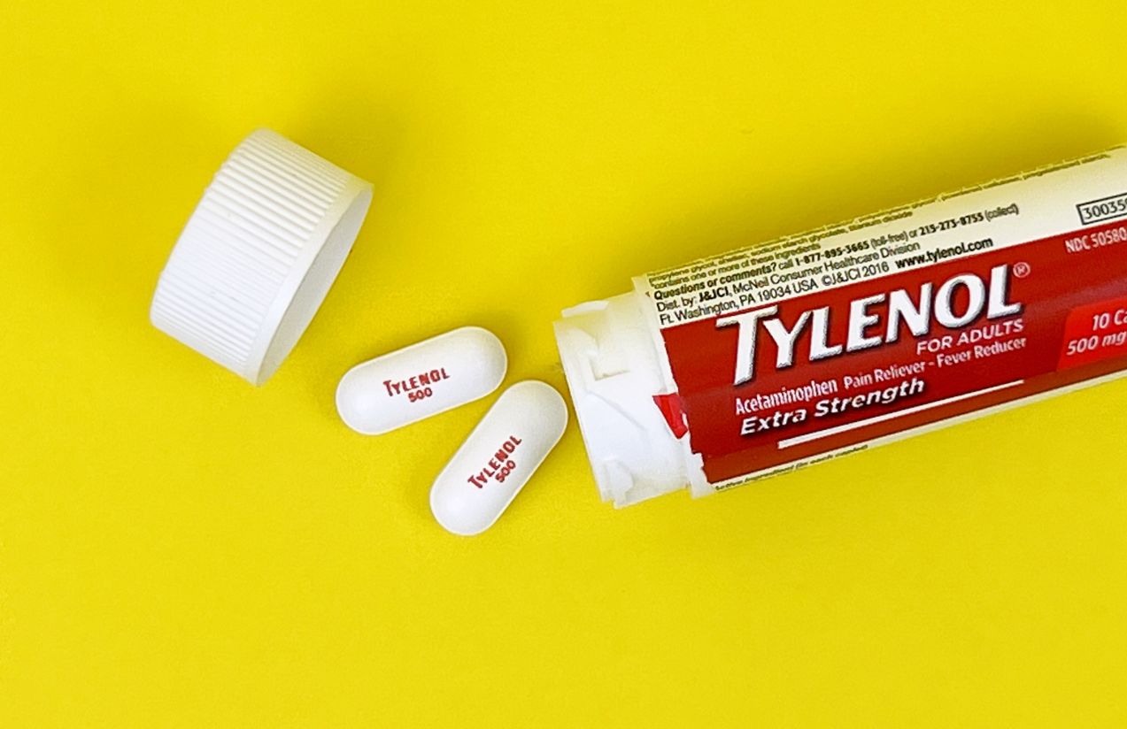 Texas sues Tylenol over alleged concealment of autism risk A bottle of Tylenol pills lying on a yellow background with two pills from its contents outside