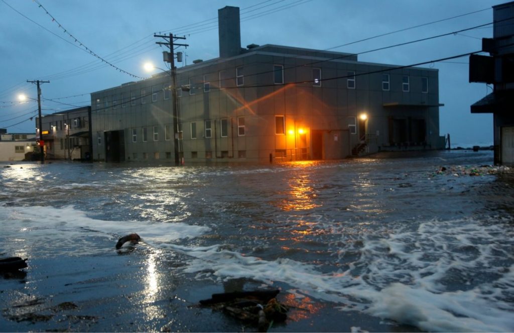 A lonely street at night on the verge of being flooded by the rising stormwaters