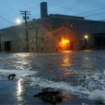A lonely street at night on the verge of being flooded by the rising stormwaters