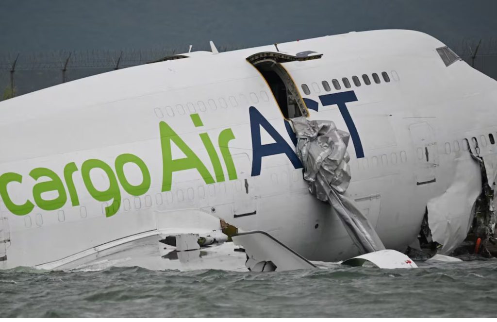 half-destroyed airplane lying in the sea near Hong Kong airport