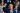 Donald Trump raising his right hand with a clenched fist during an interview, symbolizing strength and determination