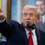 Donald Trump pointing in a direction with a very angry expression on his face