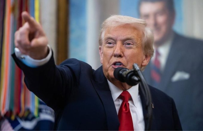 Donald Trump pointing in a direction with a very angry expression on his face