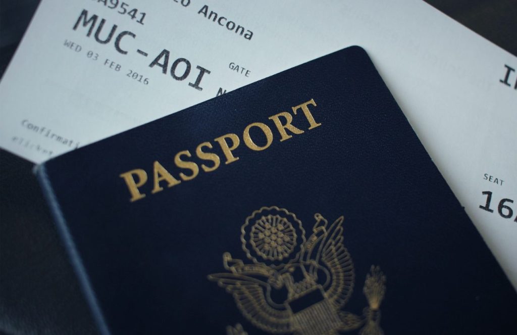 A U.S. passport holding an airplane ticket inside it