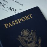 A U.S. passport holding an airplane ticket inside it