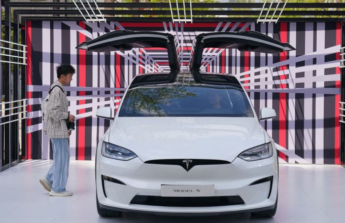 ChatGPT Plus A white Tesla car with both of its doors open upward