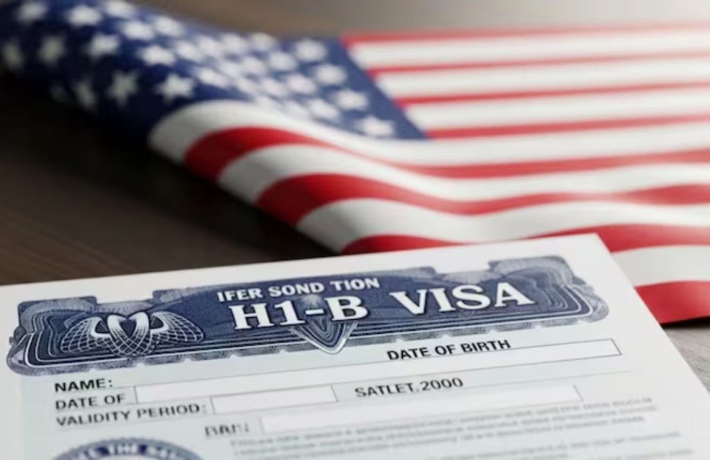 Walmart suspends hiring of foreign workers amid new United States visa fee A wooden table with a U.S. flag and one of the types of visas the country offers placed on top