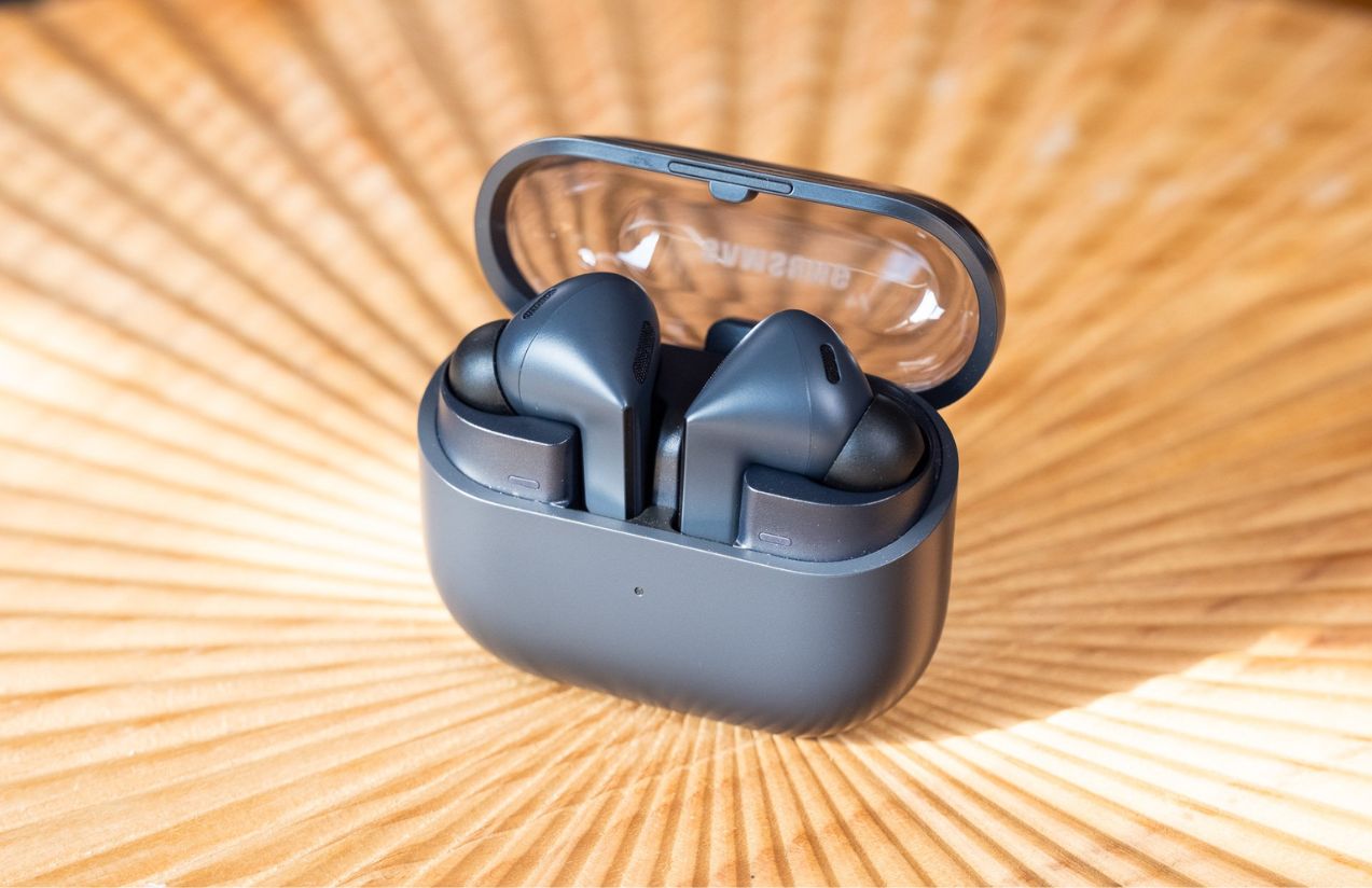 The Samsung earbuds being displayed on a wooden table