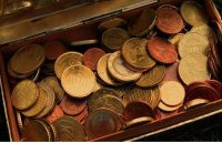 An old wooden chest filled with many gold coins