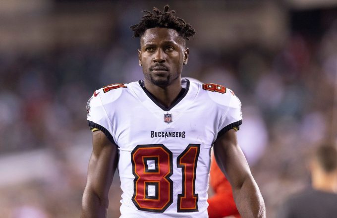 The player standing in the middle of the field with a threatening attitude, wearing his white Buccaneers uniform