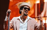 Bad Bunny happily holding the microphone while putting on an incredible show