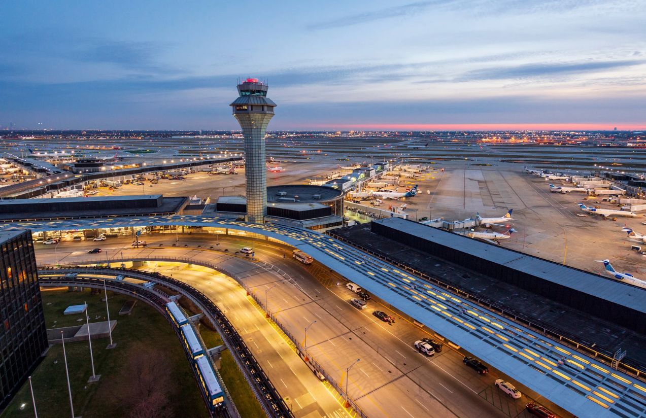 A panoramic view of the Chicago airport with a beautiful sunset in the background