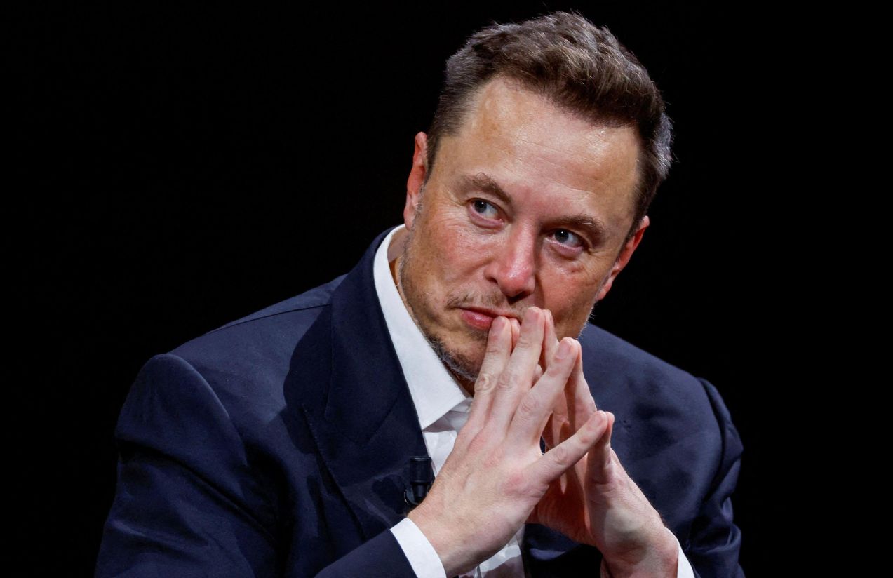 Musk focused on something while holding his hands together near his mouth