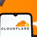 A cellphone opening the Cloudflare app with a white background and the striking orange logo