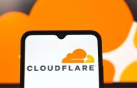 A cellphone opening the Cloudflare app with a white background and the striking orange logo