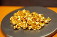 Several 22–karat gold nuggets scattered across the table