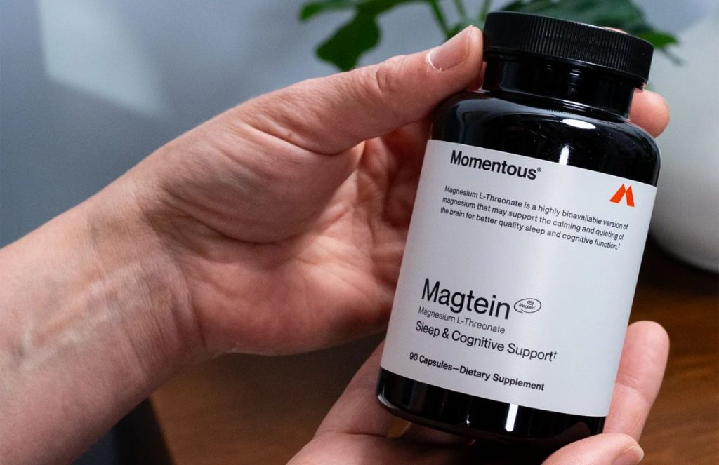 A person’s hand holding a bottle of magnesium