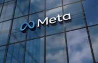 A building with many glass panels featuring the word META in blue on the front