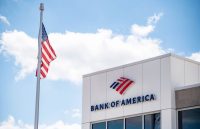 A building with the words “Bank of America” at the top, and next to it, a United States flag waving beside it