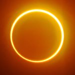 A sun covered by the moon, leaving a city in darkness