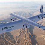 The gigantic gray airplane flying over the American sky