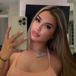 The singer and influencer taking a photo in front of the mirror