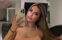 The singer and influencer taking a photo in front of the mirror