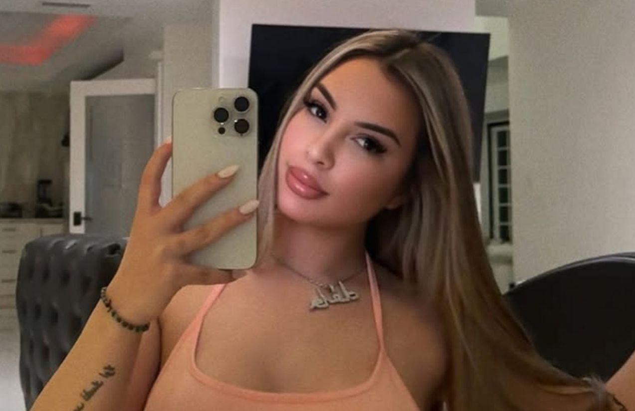 The singer and influencer taking a photo in front of the mirror