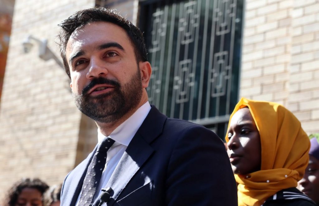 Zohran Mamdani makes history: The first muslim and youngest mayor of New York City The politician and mayor of New York wearing an elegant suit while smiling at his supporters