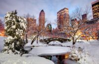 The renowned Central Park covered in snow along its paths and bodies of water