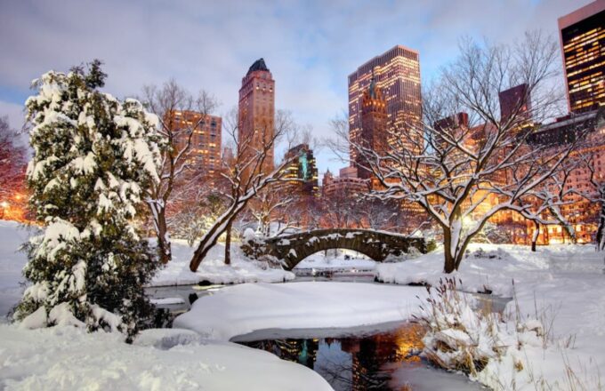 The renowned Central Park covered in snow along its paths and bodies of water